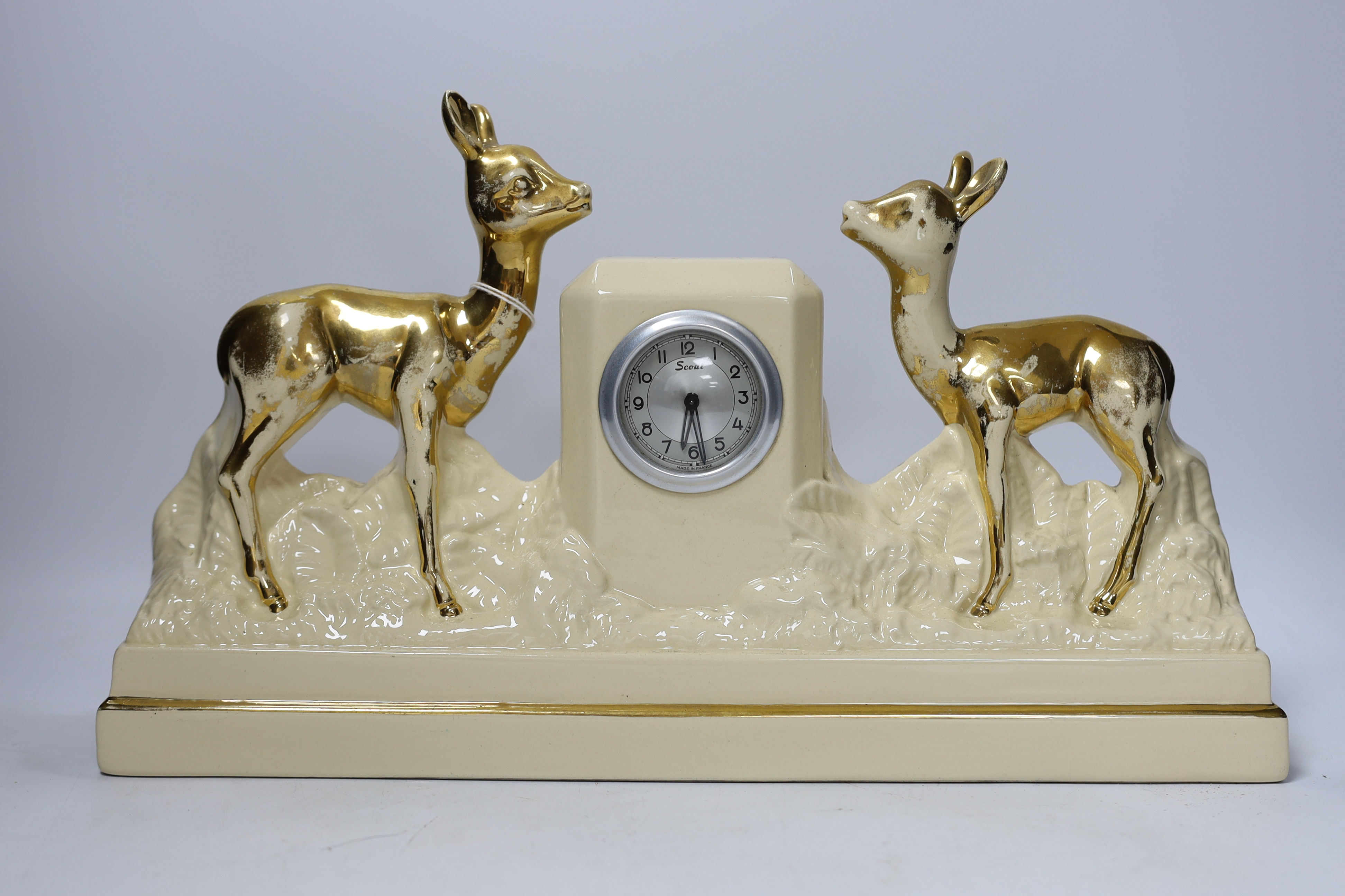 A French Art Deco green onyx clock garniture with Blue bird spelter mount, clock 46cm wide